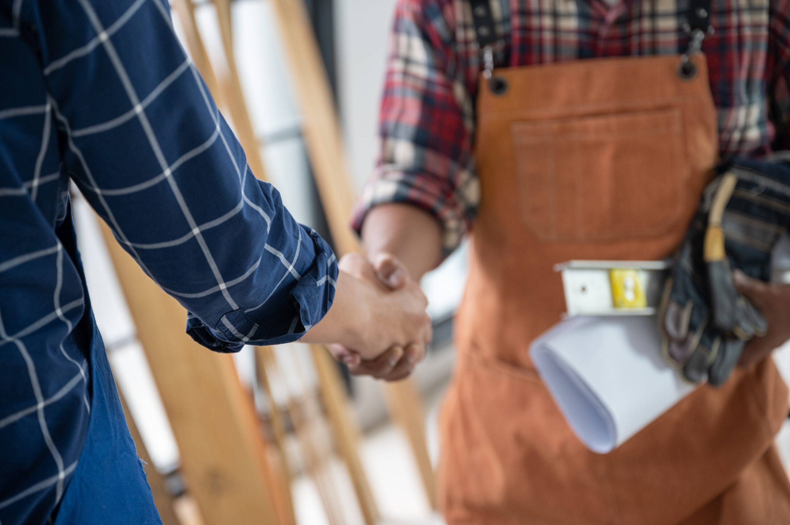 Two carpenters holding hands, The concept of working together until success